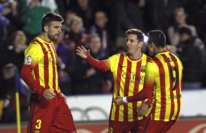 Barcelona's Gerard Pique (left) is congratulated by teammates Alexis Sanchez from Chile and Lionel Messi from Argentina after Pique scored a goal against Levante during their La Liga soccer match at the Ciutat de Valencia Stadium in Valencia, Spain on