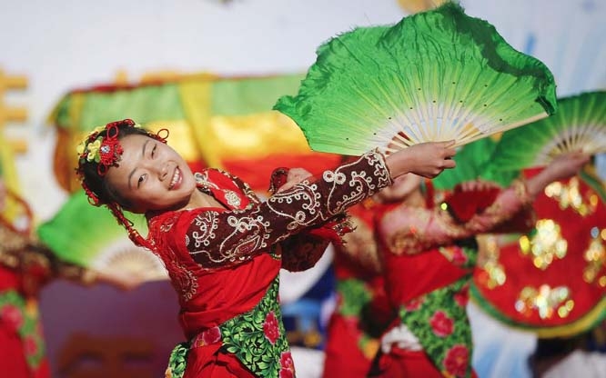 Performers in traditional costume entertain visitors on the eve of the Lunar New Year, or Spring Festival, at a park fair in Beijing.