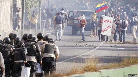 Anti-government protesters clash with riot police during a protest in Caracas, on Thursday.