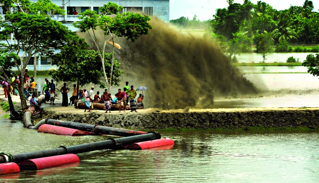 Dredging of Mongla Ghasiakhali river channel to make it operative going on in full-swing. This photo was taken from Kaligonj Bazar point in Rampal on Wednesday.