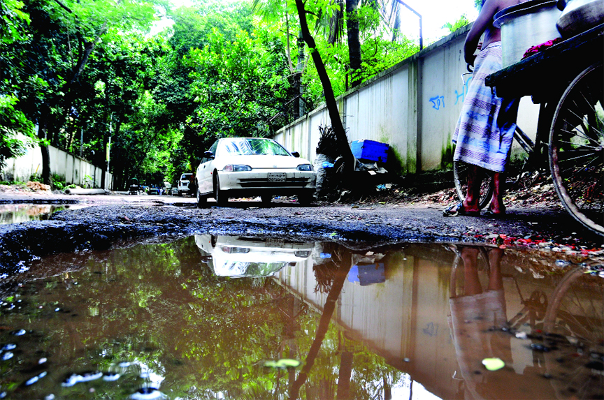 In absence of repairing and proper maintenance city's Banani Graveyard Road became totally unfit for vehicular movement. This photo was taken on Thursday.