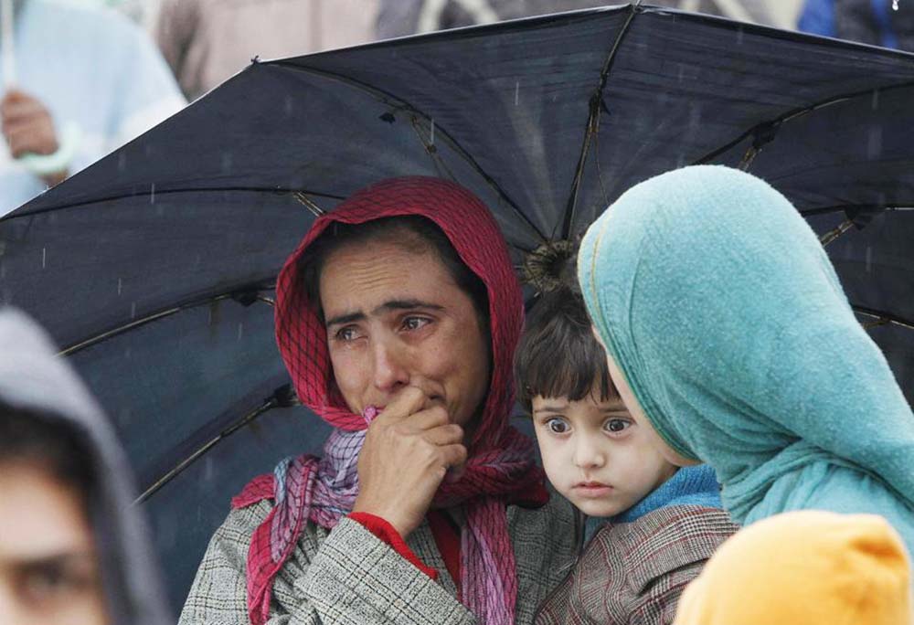 A Kashmiri woman cries as she looks at a road covered with floodwater in Srinagar.