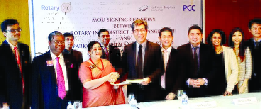 . Rtn Safina Rahman, District Governor, Rotary International District 3281, Bangladesh and Alvin Neo, Chief Marketing Officer, Parkway Hospital, Singapore exchanging documents after signing a MoU at Hotel Westin in the city on Friday.
