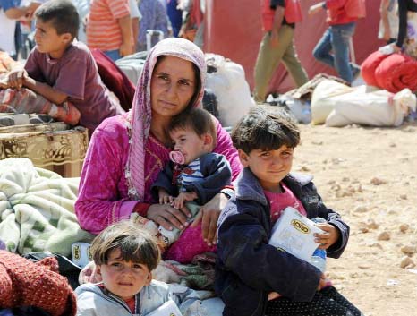 Kurdish Syrian refugees rests after crossing the Turkish-Syrian border near the southeastern town of Suruc in Sanliurfa province.
