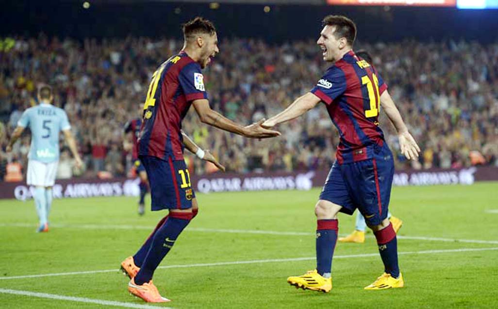 FC Barcelona's Lionel Messi from Argentina (right) reacts after scoring with his teammate Neymar from Brazil during a Spanish La Liga soccer match at the Camp Nou stadium against Eibar in Barcelona, Spain on Saturday.