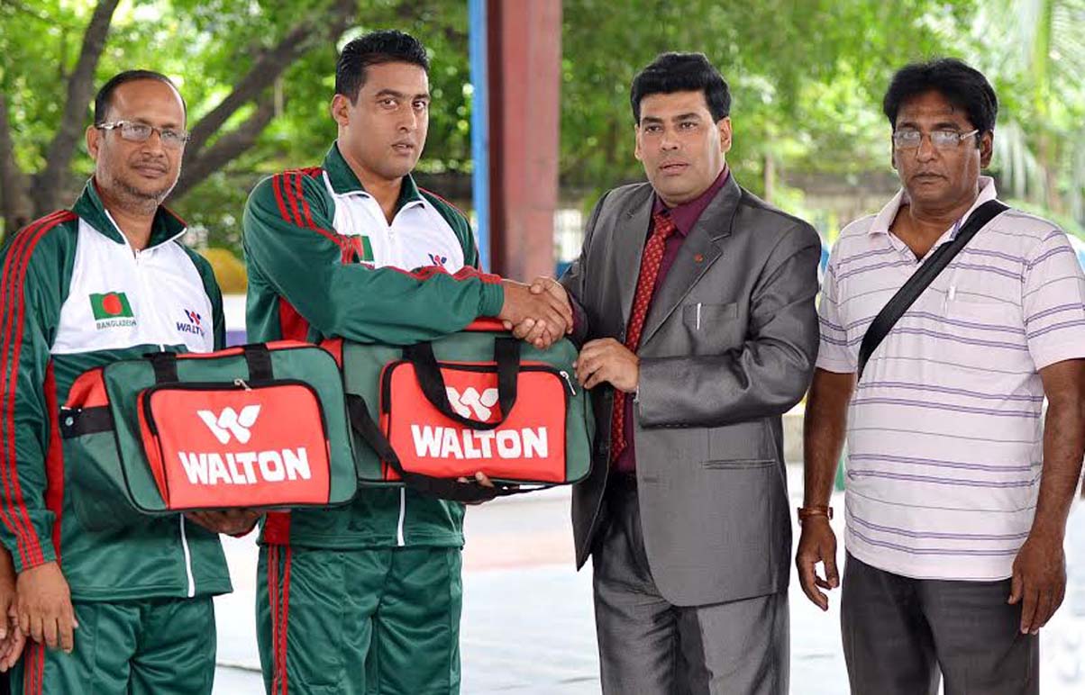 Vice-President of Bangladesh Amateur Wrestling Federation (BAWF) and Additional Director of Walton FM Iqbal Bin Anwar Dawn shaking hands with wrestler Md Rafiqul Islam at the Shaheed (Capt) M Mansur Ali National Handball Stadium on Wednesday. Member of BA