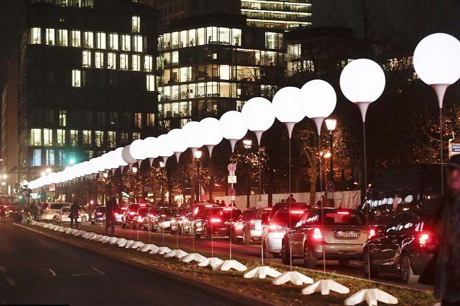 Illuminated white balloons, seen here near the Brandenburg Gate, mark the route of the Berlin Wall.