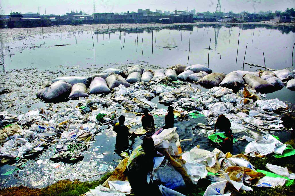Used polythene bags being washed in city's Beribandh (Cross Dam) area along Buriganga river polluting the water as well as environment. This photo was taken on Thursday.