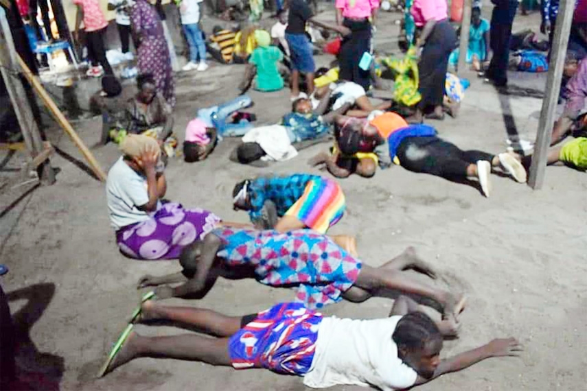 Dead bodies and injured people are lying on the floor.