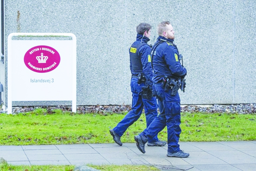 Armed police officers patrol the court of Roskilde's specially built courtroom.