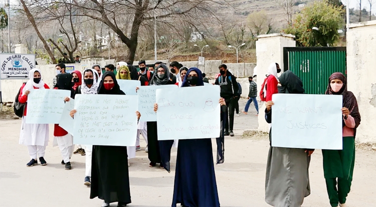 Students hold placards during a protest over the hijab ban imposed in the few colleges in Karnataka at Government Degree College, Mendhar, in Poonch district of Jammu and Kashmir on Friday.