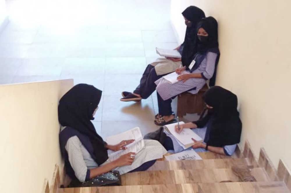 The photo of girls sitting on the stairs of a college in Udupi after they were denied entry into classroom that went viral on social media. Agency photo