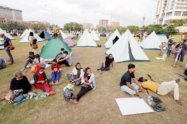 Demonstrators sit in a protest area near Colombo's presidential secretariat.