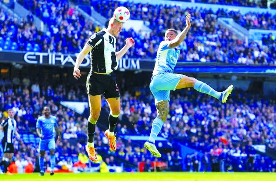 Newcastle's Dan Burns (left) heads the ball past Manchester City's Gabriel Jesus during the English Premier League soccer match at Etihad stadium in Manchester, England on Sunday. AP photo