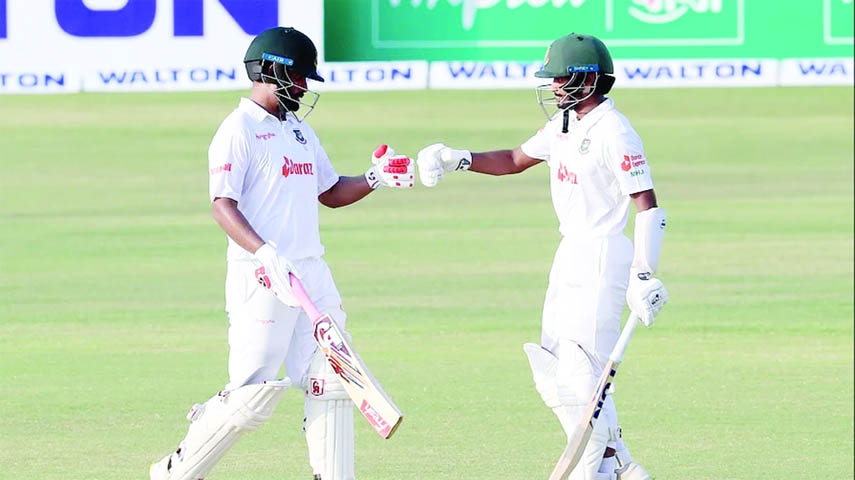 Tamim Iqbal (left) of Bangladesh and his teammate Mahmudul Hasan Joy toast after hitting a four against Sri Lanka during the second day play of the first Test cricket match at the Zahur Ahmed Chowdhury Stadium in Chattogram on Monday.