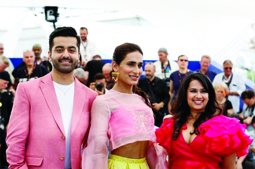 Director Saim Sadiq, cast member Alina Khan and producer Apoorva Guru Charan pose in Cannes