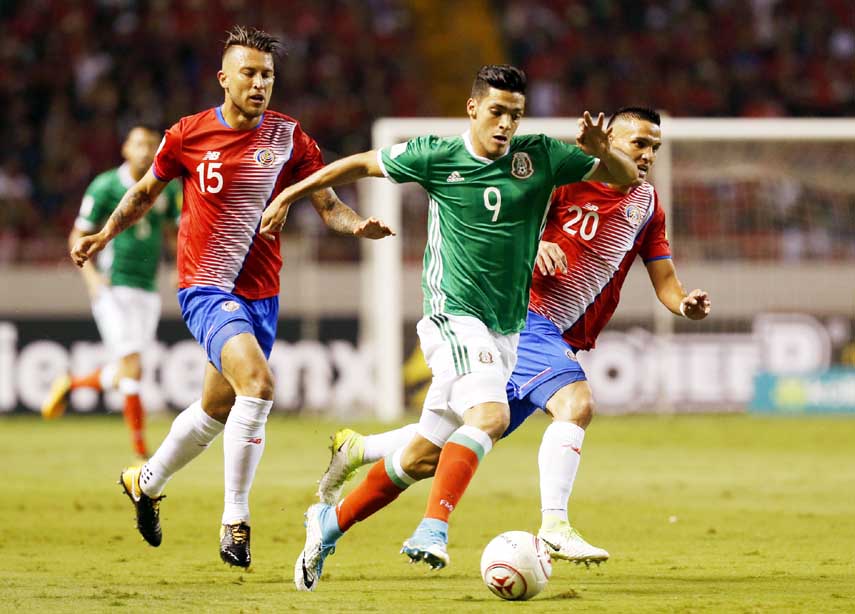 Mexico's Raul Jimenez (center) dribbles past Costa Rica's Francisco Calvo (left) and David Guzman during a 2018 Russia World Cup qualifying soccer match at the National Stadium in San Jose, Costa Rica on Tuesday.