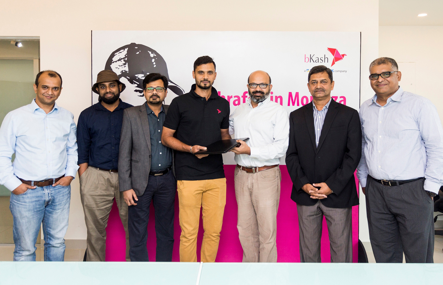 Kamal Quadir, Chief Executive Officer of bKash Limited along with senior officials of the company poses with Mashrafe Bin Mortaza, the captain of Bangladesh national cricket team in One day International while announcing the cricketer as the brand ambassa