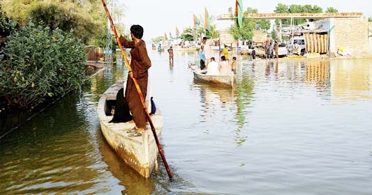 File photo: Residents use boats as they travel amid floodwater, following rains and floods during the monsoon season in Bajara village, at the banks of Manchar lake, in Sehwan, Pakistan in September.
