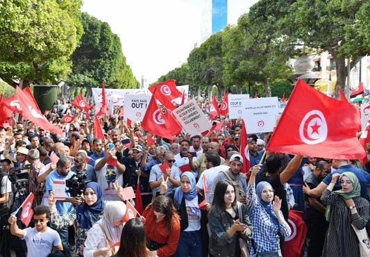 Supporters of the Tunisian Destouri party wave national flags and raise placards during a demonstration against President Kais Saied in the capital Tunis on Saturday.