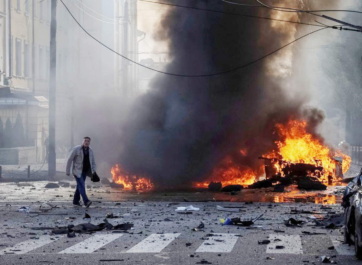 File photo: A driver walks near his burned car after Russian military strike, as Russia's invasion of Ukraine continues, in central Kyiv, Ukraine recently. Agency photo
