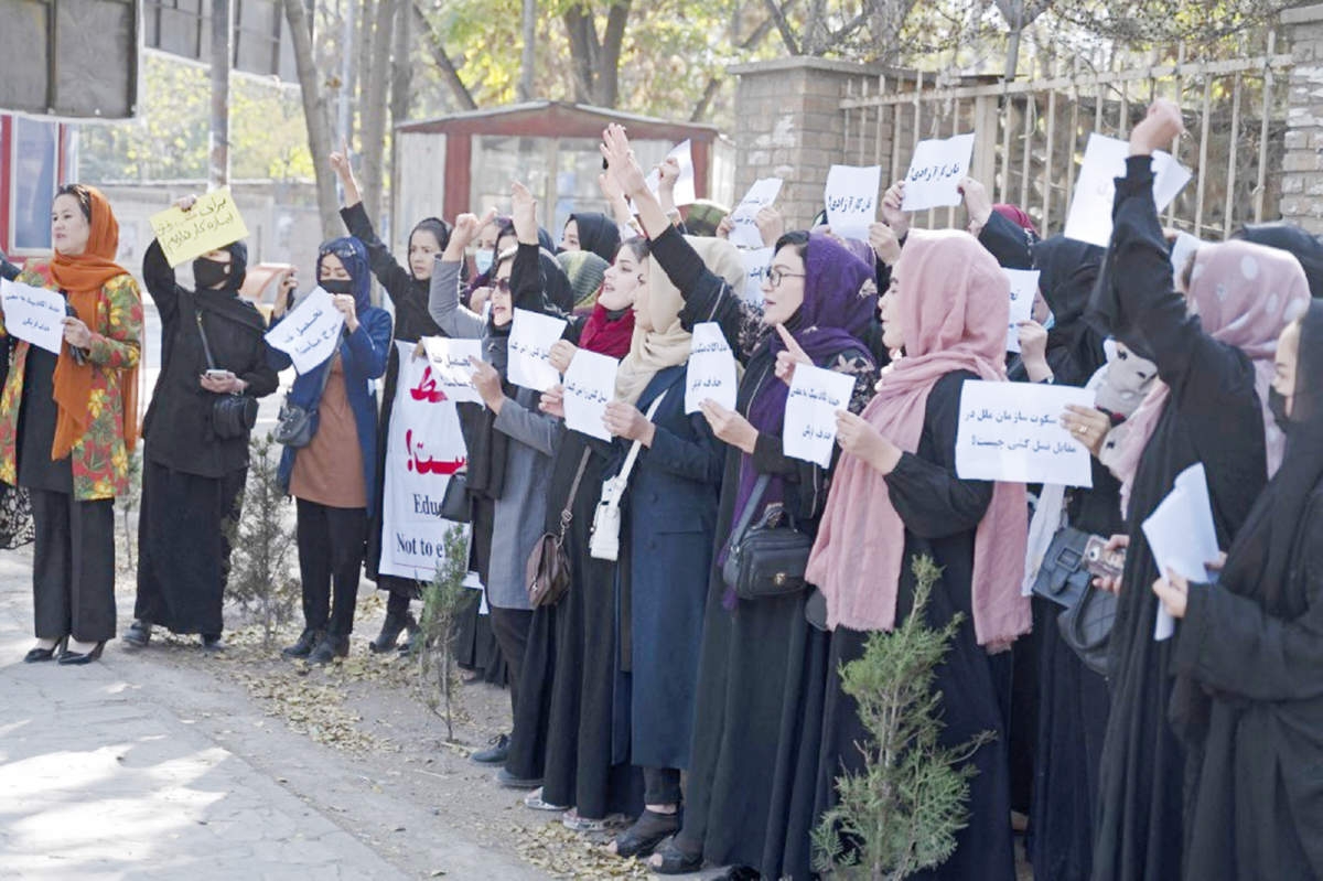 Afghan women hold placards during a protest in front of Kabul University in Kabul on Tuesday. Agency photo