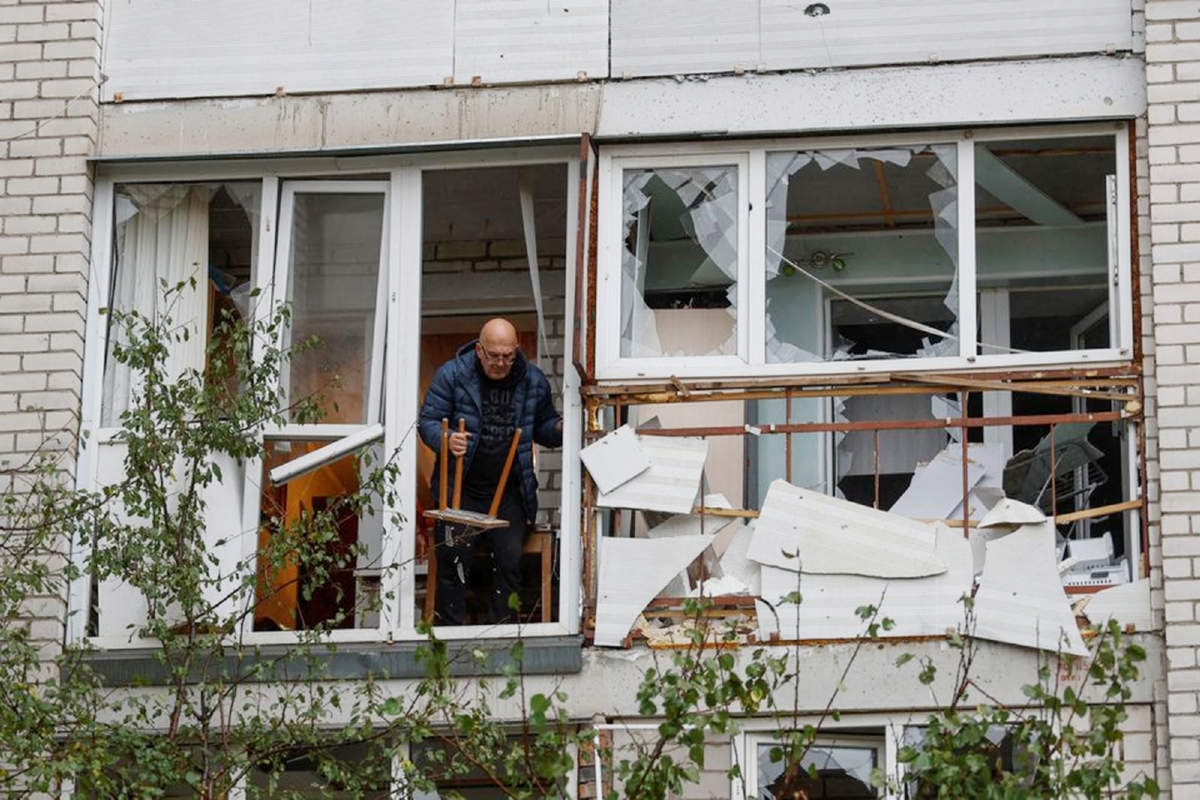 A local man throws debris out of a broken window in a residential building heavily damaged by a Russian missile attack in Mykolaiv, Ukraine on Sunday. Agency photo