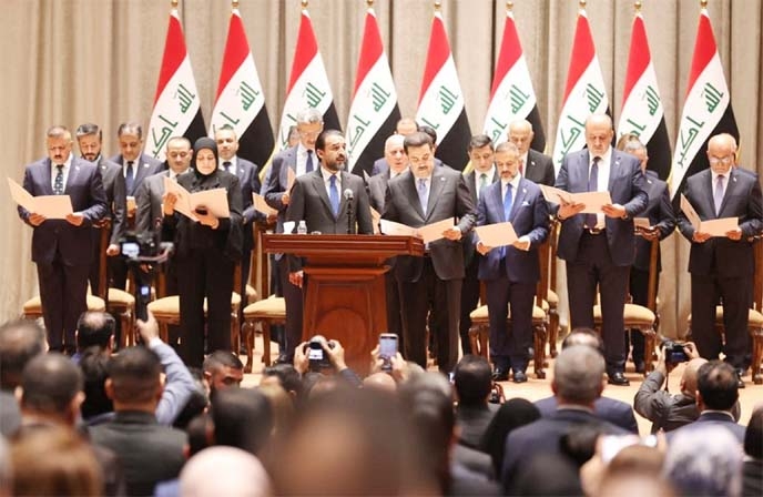A handout picture released by the Iraqi parliament shows Parliament Speaker Muhammad al-Halbousi, on the centre, announcing the result of a confidence vote on Prime Minister Mohammed Shia al-Sudani's, fro centre to the right, new government, on Thursday.