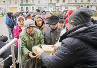 Local residents stand in line waiting for free bread from volunteers in Bakhmut, the site of the heaviest battle against the Russian troops in the Donetsk region, Ukraine on Friday.