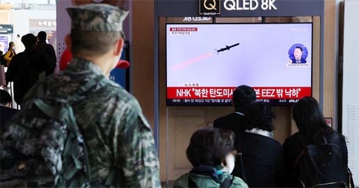 People watch a TV broadcasting a news report on North Korea firing three ballistic missiles into the sea, in Seoul, South Korea on Wednesday.