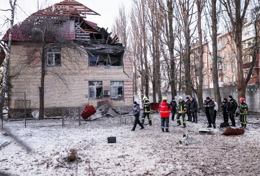 Rescuers and police officers examine parts of the drone at the site of a building destroyed by a Russian drone attack, as their attack on Ukraine continues, in Kyiv, Ukraine on Wednesday.