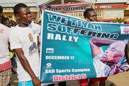 Demonstrators hold a banner as they protest over the economic hardship and President Weah's prolonged absence from the country, in Paynesville, a suburb of Monrovia, Liberia on Saturday.