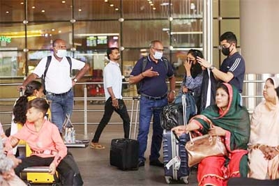 Passengers wait with their luggage at the Chhatrapati Shivaji Maharaj International Airport in Mumbai, India on Friday.