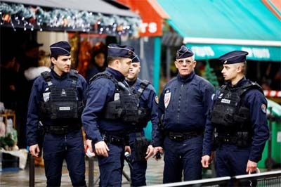 French police secure a street after gunshots were fired killing two people and injuring several in a central district of Paris, France on Friday.