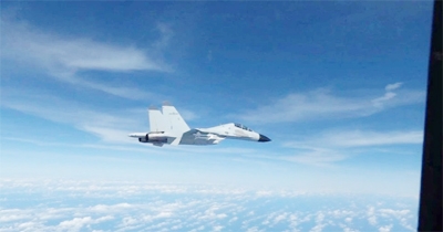 File photo: A Chinese Navy J-11 fighter jet is recorded flying close to a US Air Force RC-135 aircraft in international airspace over the South China Sea, according to the US military, in a still image from video taken December 21, 2022.