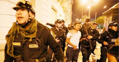 Security forces detain a demonstrator during a protest to demand the dissolution of Congress and democratic elections, in rejection of Dina Boluarte as Peru's president, after the ouster of leftist President Pedro Castillo, in Lima, Peru on Thursday.
