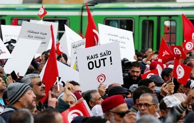 Demonstrators attend a protest against Tunisian President Kais Saied, on the anniversary of the 2011 uprising, in Tunis, Tunisia on Saturday.