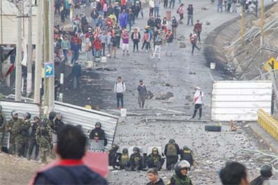 Police block demonstrators from getting closer to the airport in Arequipa, Peru, on Thursday.