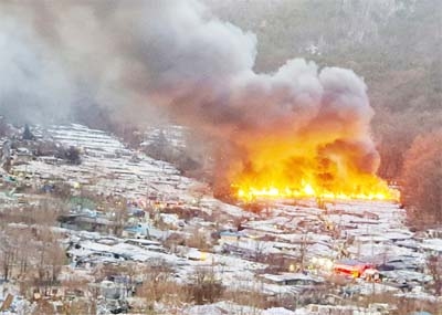 Smoke rises from a fire at Guryong village, the last slum in the glitzy Gangnam district, in Seoul, South Korea on Friday.