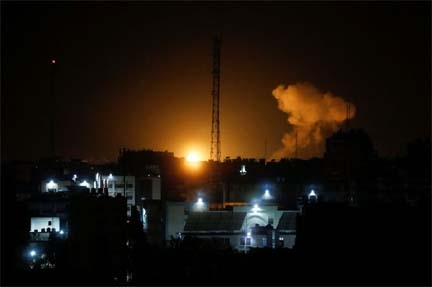 Smoke and flames rise during Israeli airstrikes in Gaza City, on Friday.