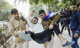 Police personnel detain members of Bhim Army Student Federation for planning to screen the BBC documentary film 'India: The Modi Question', at Delhi University Arts Faculty on Friday.