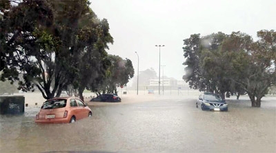 Cars are seen in a flooded street during heavy rainfall in Auckland, New Zealand on Friday.