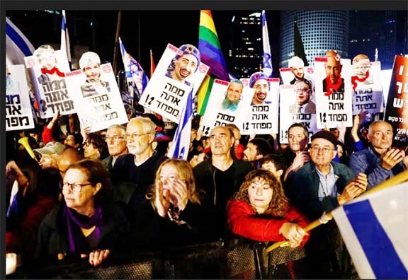 Israelis hold signs with faces of politicians with the slogan 'What are you afraid of?' during a protest in Tel Aviv, Israel Agency photo