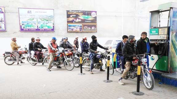 People wait for their turn to get fuel at a petrol station in Peshawar, Pakistan. Credit: Reuters Photo