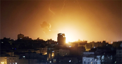 Fire and smoke rise above buildings in Gaza City as Israel launched air strikes on the Palestinian enclave early on Thursday.