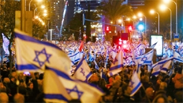 Israelis hold flags as they protest against Prime Minister Benjamin Netanyahu's new right-wing coalition and its proposed judicial reforms in Tel Aviv, Israel on Saturday.