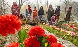 Relatives of slain Kashmiri fighters gather around graves at a graveyard in Waddur village, in India-held Kashmir near the Line of Control.
