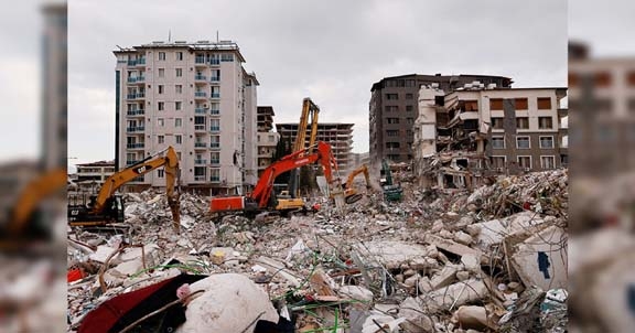 Workers clean the rubble of a collapsed building in the aftermath of a deadly earthquake in Antakya on Monday. Agency photo