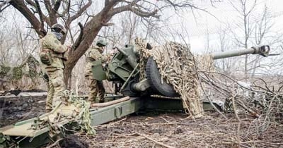 Ukrainian service members prepare to shoot from a howitzer at a front line, as Russia's attack on Ukraine continues, near the city of Bakhmut, Donetsk region, Ukraine on Thursday..