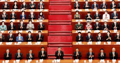 Chinese President Xi Jinping and other officials applaud at the opening session of the National People's Congress (NPC) at the Great Hall of the People in Beijing, China on Sunday.